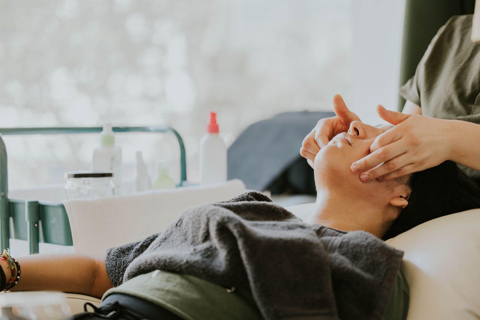 A guest resting during a warm facial treatment at Lani's Rejuvenation Escape